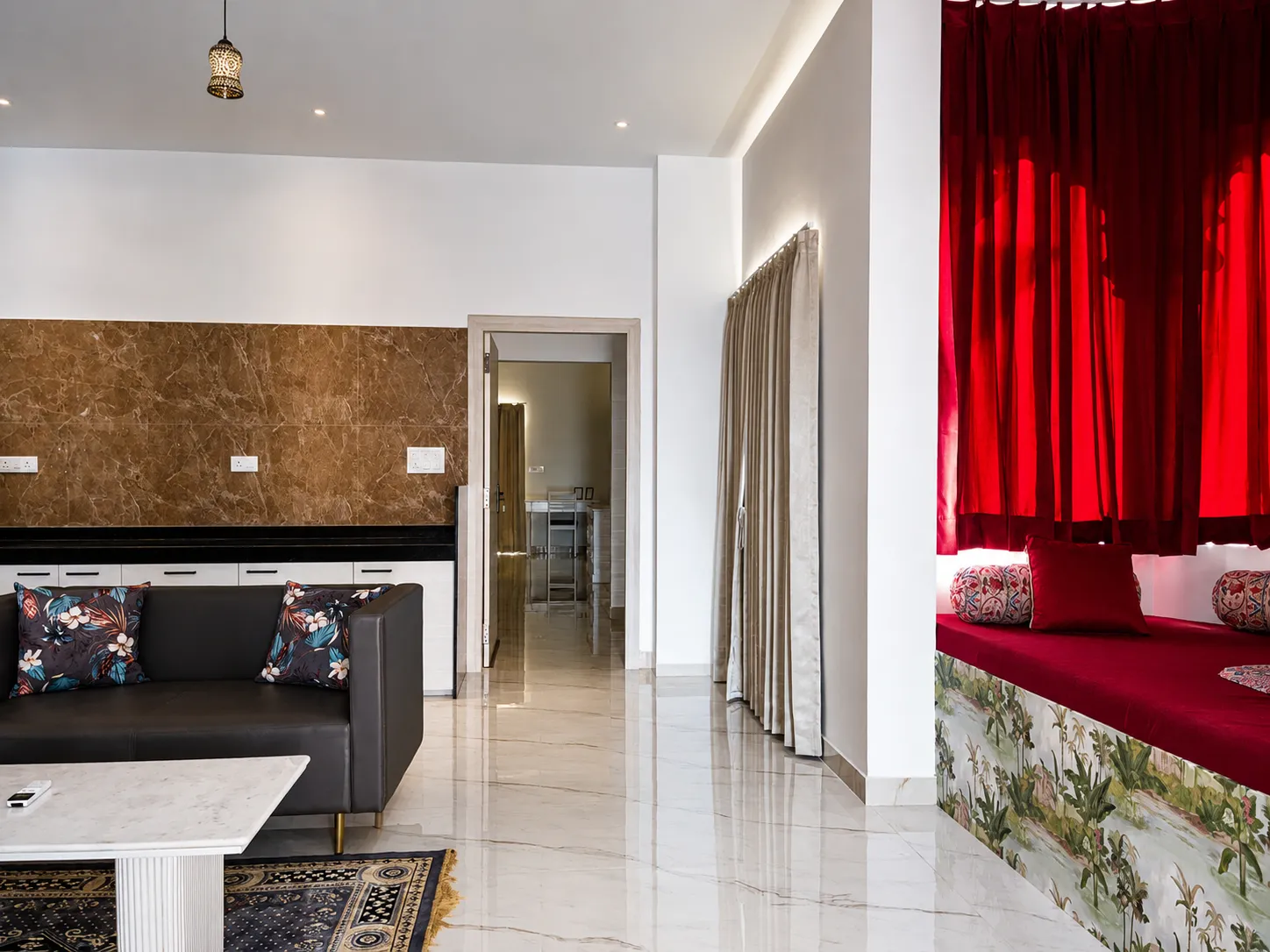 The lounge's red velvet nook and brown marble kitchenette