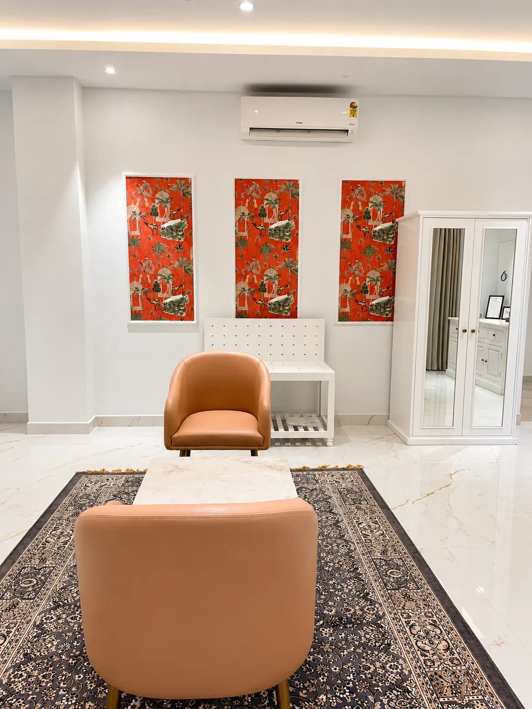 Dressing corner with orange palm-motif panels and mirrored wardrobe