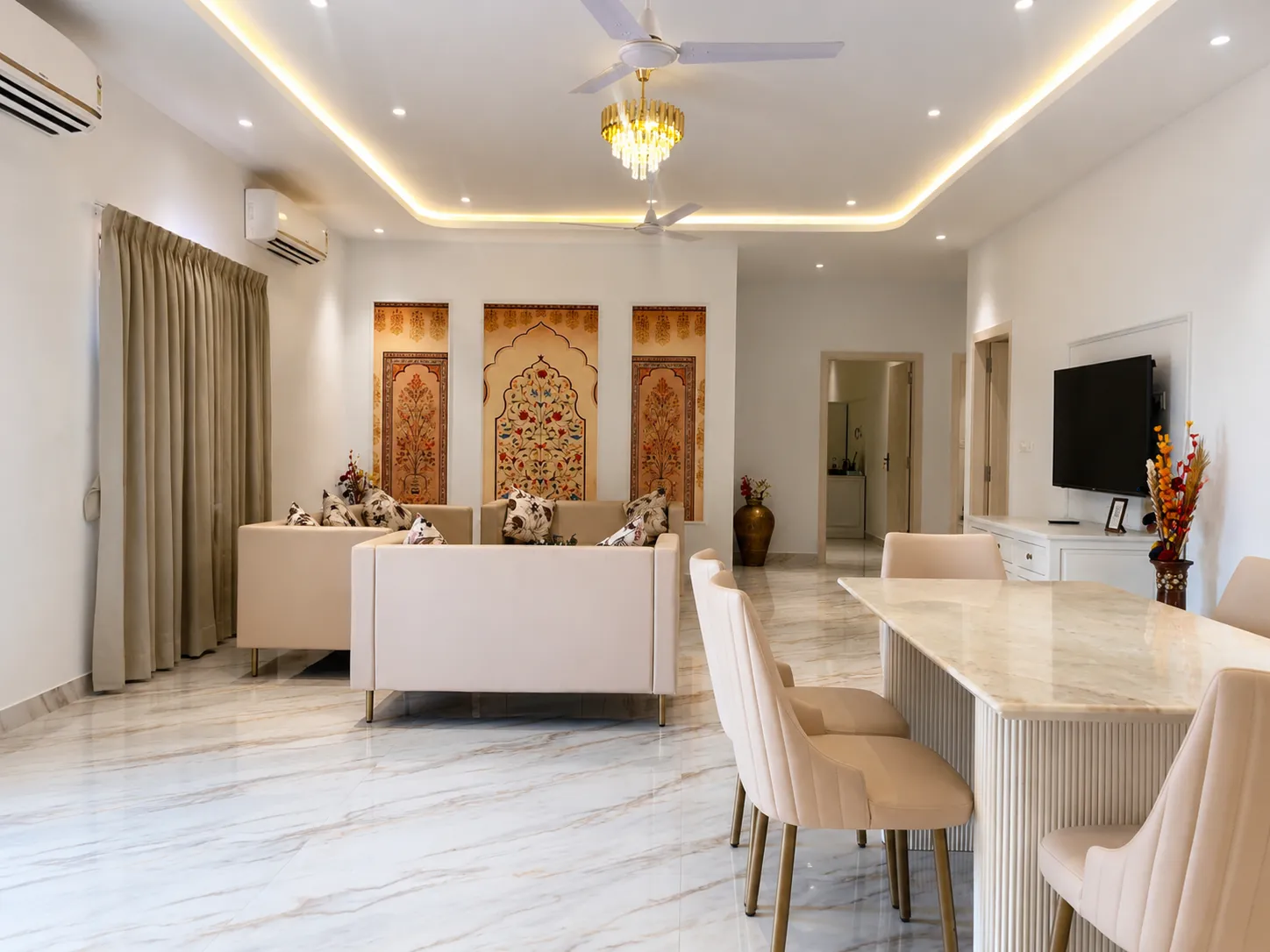 Ivory floor lounge with cream sofas and Mughal floral art panels