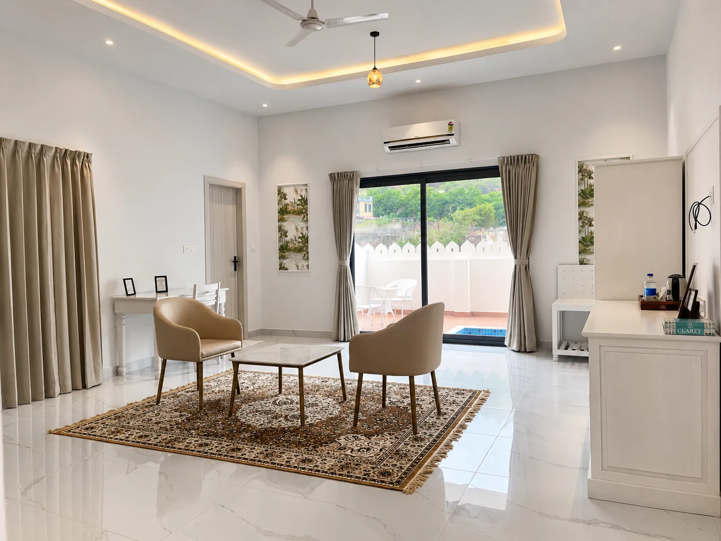 A suite's living space opening through sliding glass doors onto a private terrace pool